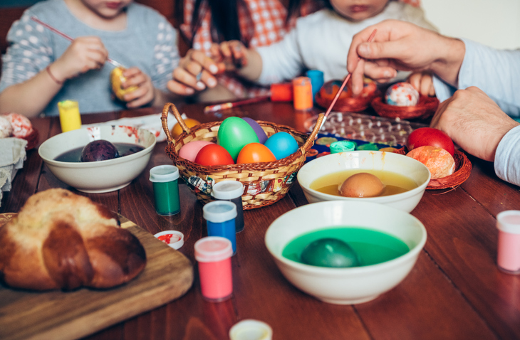 Happy family painting Easter eggs Happy family painting Easter eggs