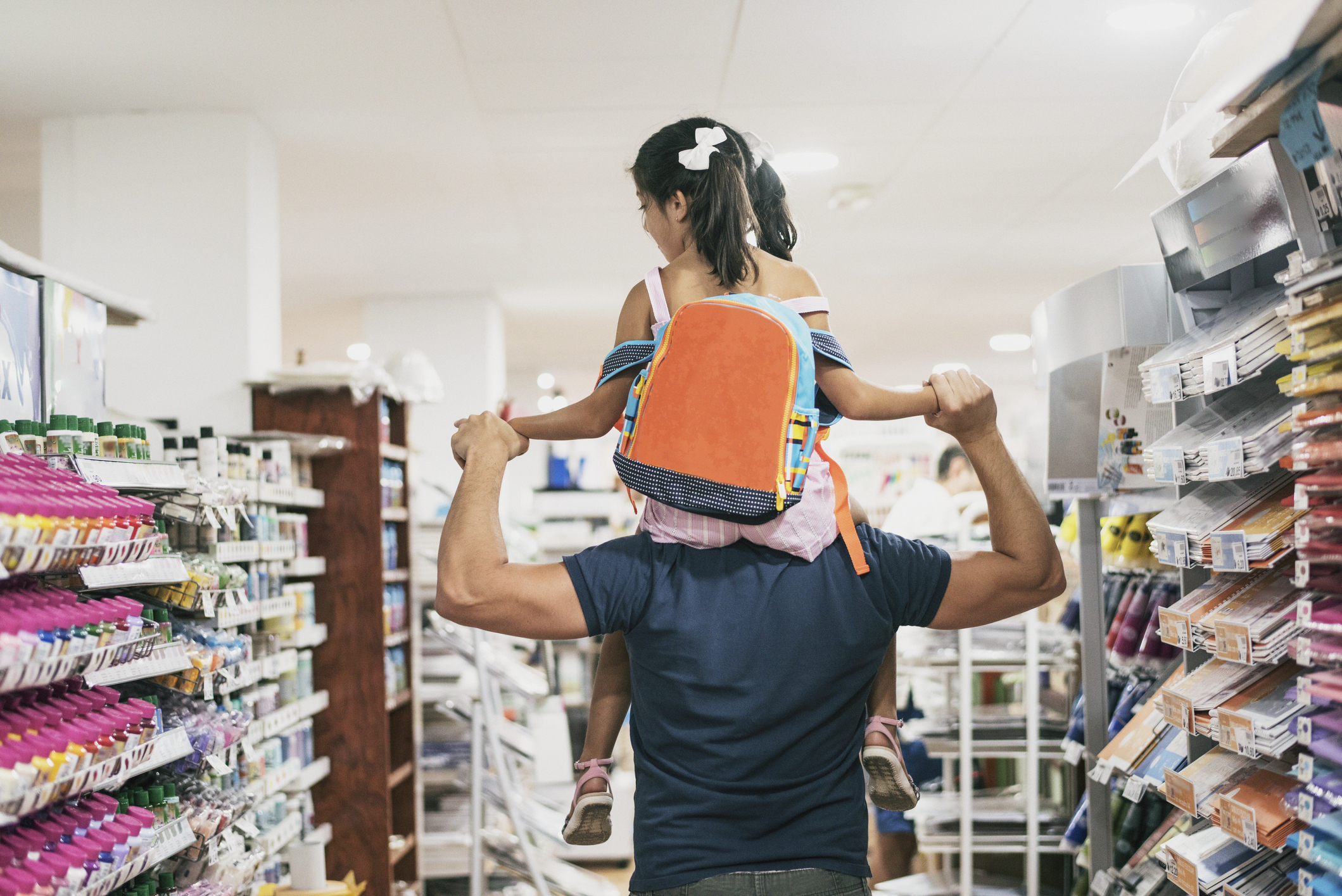 Father and daughter buying school supplies preparing to go back to school, on shoulders Father and daughter buying school supplies preparing to go back to school, on shoulders
